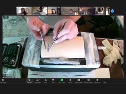 A course TA demonstrating suturing techniques.